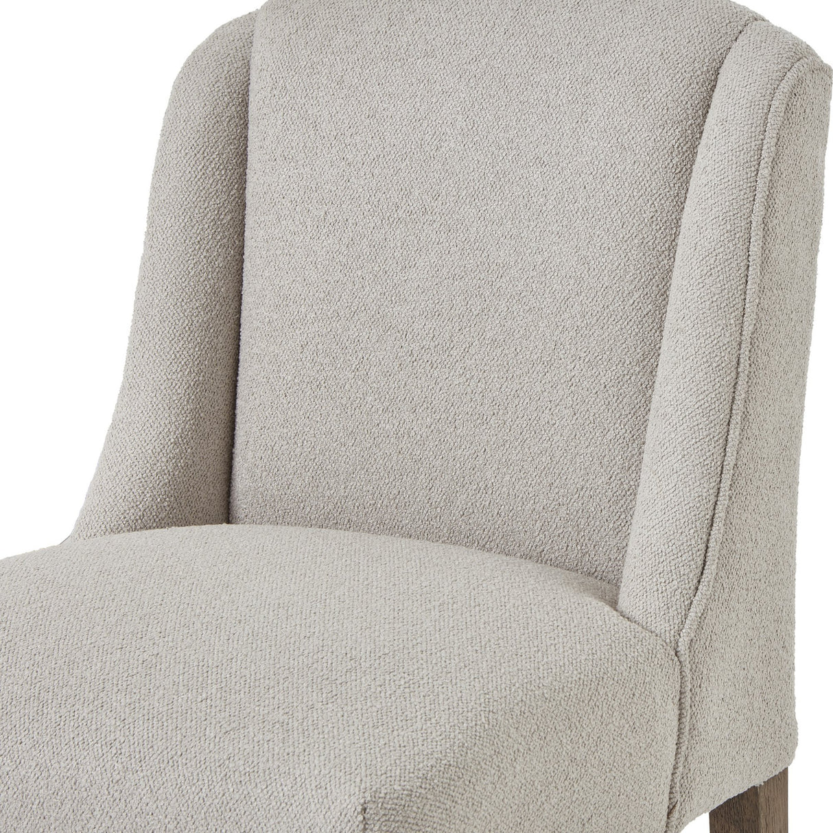 Close-up of the Hill Interiors Braxdon Aspen Wooden Dining Chair showing the light neutral upholstered seat and gently sloping backrest.