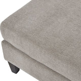 Close-up of the Hill Interiors Upholstered Ottoman Foot Stool in beige, showing the woven fabric top, cushioned edge and dark wooden leg.