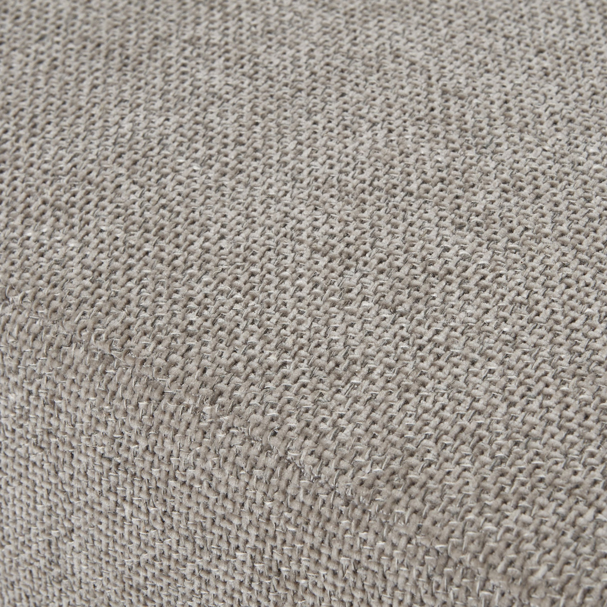 Close-up of the Hill Interiors Upholstered Ottoman Foot Stool in beige, showing the woven fabric texture and gently padded, rounded surface.