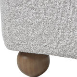 Close-up of Hill Interiors Large Arm Accent Chair showing greige-beige boucle upholstery and a rounded spherical wooden ball foot in a warm brown finish.