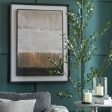 Hill Interiors extra large brown abstract painting on linen in solid wood frame, hung on a green panelled living room wall beside an olive tree.