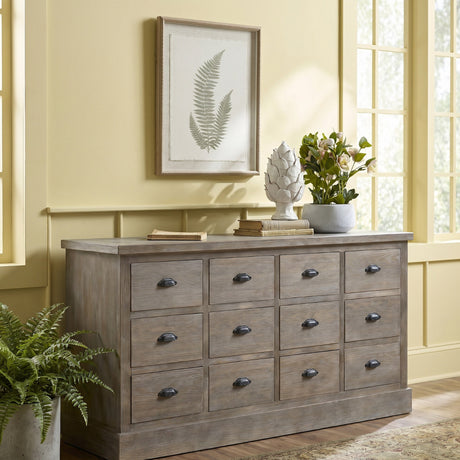 Hill Interiors fern botanical print in a white beaded frame, hung above a wooden drawer chest with decor in a sunlit yellow living room.