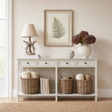 Hill Interiors Bracken Botanical framed print in a slim white beaded frame, hung above a cream console styled with a lamp, hydrangeas and wicker baskets.