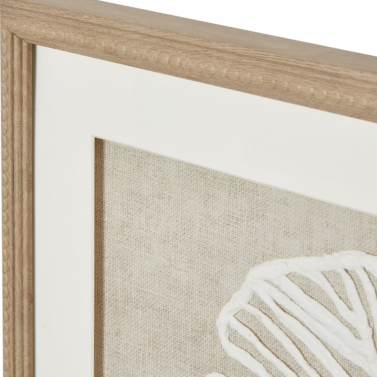 Close-up of Hill Interiors Large Feather Wall Art showing wood beaded frame, white mount, and textured linen background with white feather detail.