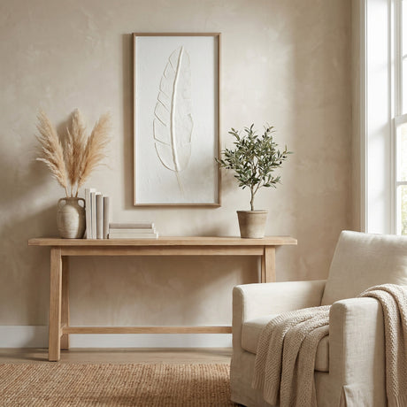 Hill Interiors Large Quill White Feather Print in beaded frame, portrait wall art above a wooden console table with pampas grass and olive tree.