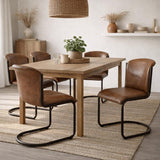 Hill Interiors Curved Leather Dining Chairs in brown with black metal cantilever frames, set around a wooden dining table in a neutral styled room.