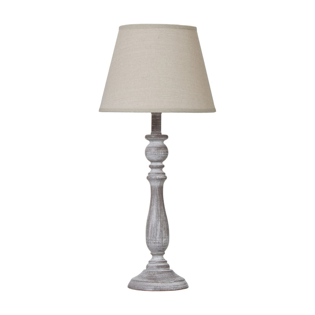 Hill Interiors Column Table Lamp with turned wooden base in soft white finish, topped with a natural linen tapered shade, on a plain background.