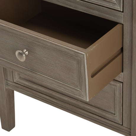 Hill Interiors grey wooden three-drawer bedside table close-up with open middle drawer, round brushed nickel knob and grained painted finish.