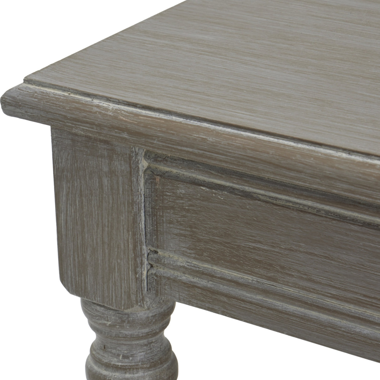 Close-up of Hill Interiors Rattan Coffee Table in brown, showing the distressed wood corner, panelled apron detail and turned leg.