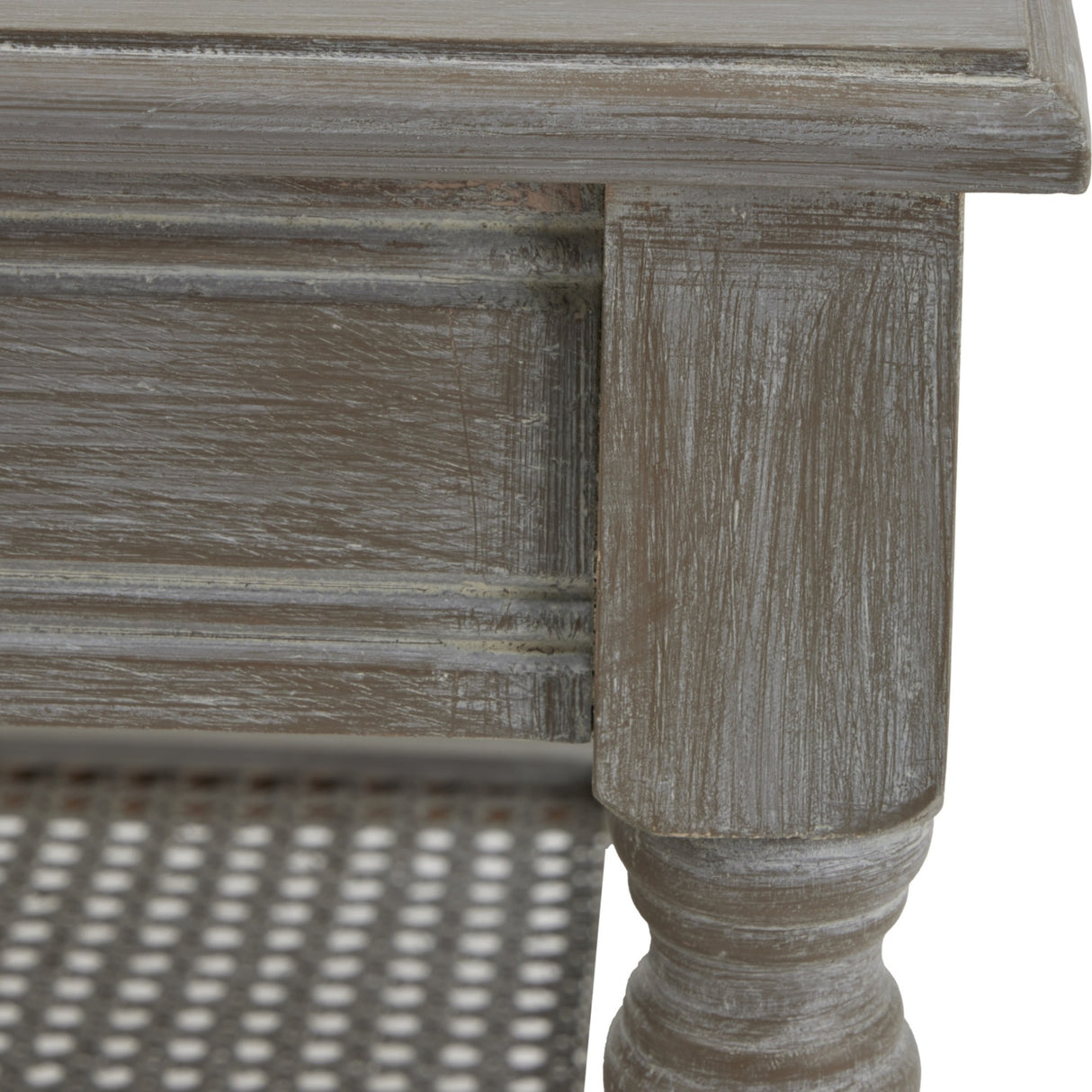 Close-up of Hill Interiors Rattan Coffee Table in brown, showing the distressed wood frame, turned leg detail and woven cane lower shelf.