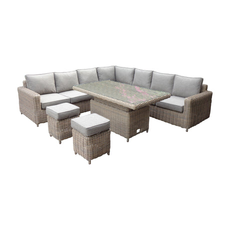 Hill Interiors Ferranock outdoor large corner set in beige woven rattan with grey cushions, glass-topped riser table and two matching stools.