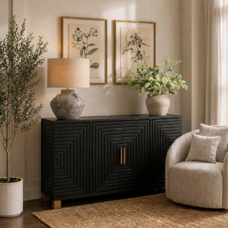 Hill Interiors Harweld 2-Door Sideboard in matte black wood with geometric ridged doors and brass handle, styled in a living room with lamp and vase.