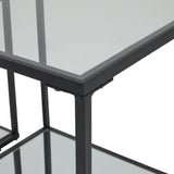 Close-up of the Hill Interiors Harweld side tables showing the slim black metal frame corners and clear glass tops of the nesting pair.