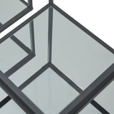 Close-up of the Hill Interiors Harweld side tables showing slim black metal frames and clear glass tops meeting at the corners.