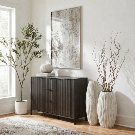 Hill Interiors Large Fin Ceramic Vase in white with a tall fluted body, styled on a living room floor with curly willow branches beside a dark sideboard.