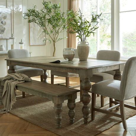 Hill Interiors 200cm rectangular dining table in solid brown wood with turned bulbous legs, styled with upholstered chairs and a bench in a bright dining room.