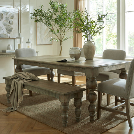 Hill Interiors Rectangular Wooden Bench in brown with turned legs, styled beside a matching dining table and upholstered chairs on a jute rug.