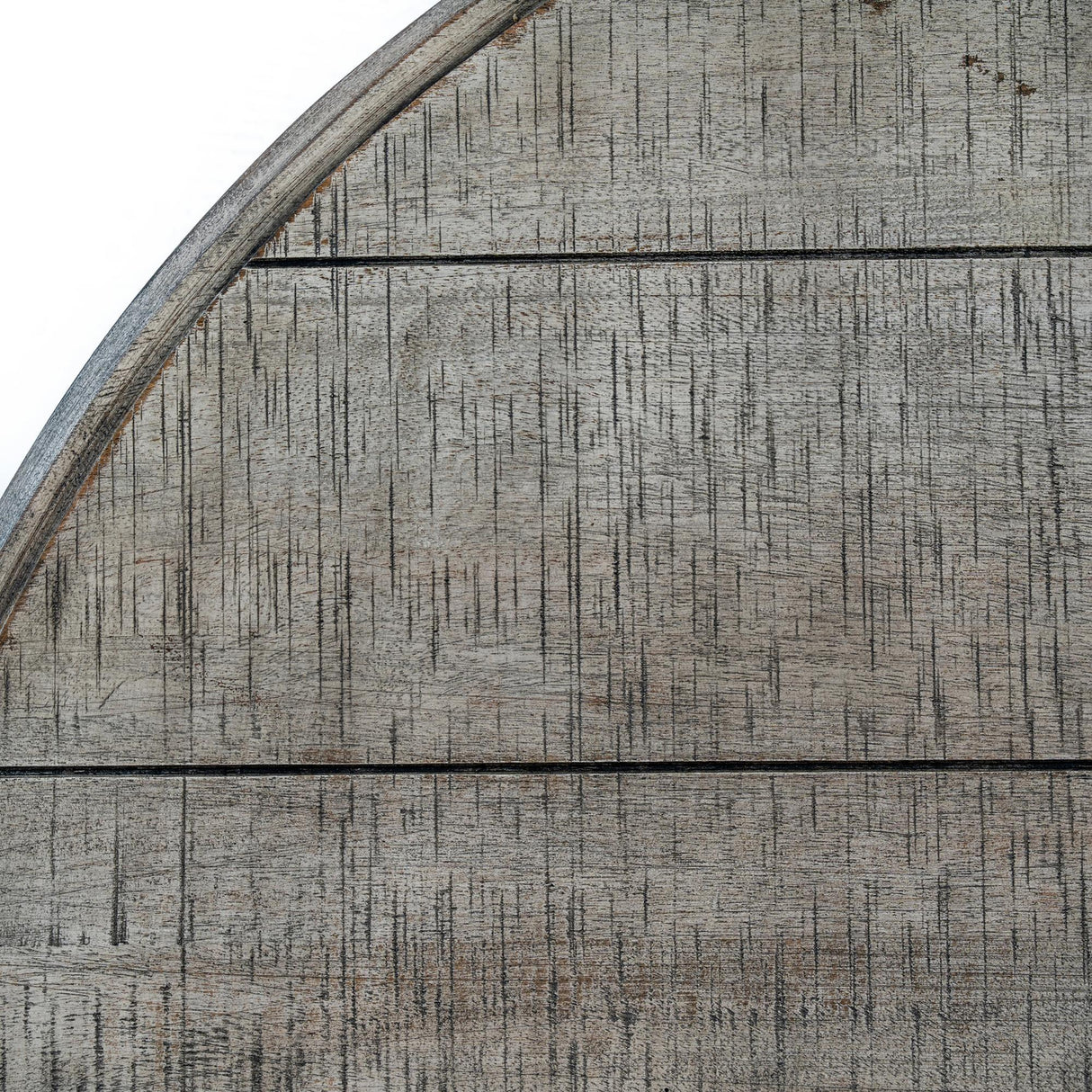 Close-up of Hill Interiors Round Wooden Coffee Table in brown, showing the curved edge and textured timber grain across horizontal planks.