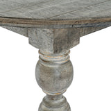 Close-up of Hill Interiors Round Wooden Dining Table in brown, showing the grained tabletop edge and turned baluster pedestal leg with a weathered grey finish.