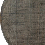 Close-up of the Hill Interiors Round Wooden Dining Table in brown, showing the plank-effect tabletop with visible grain and rustic weathered finish.