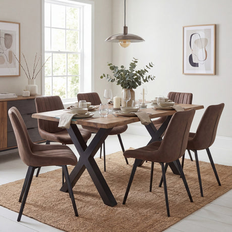 Hill Interiors Live Edge Acacia River Dining Table with black X-shaped metal legs, styled with brown chairs in a bright dining room.