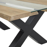 Close-up of Hill Interiors Live Edge Acacia River coffee table showing the brown wood edge, glass inset top and black powder-coated X-shaped metal base.