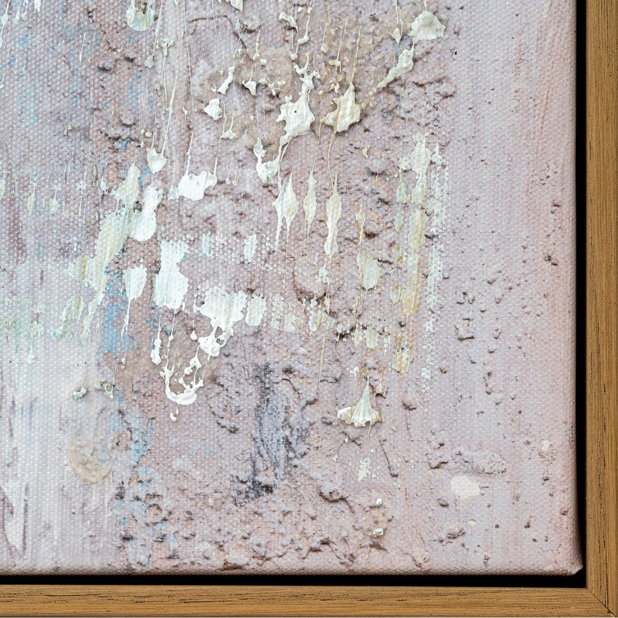 Close-up of Hill Interiors hand painted canvas wall art corner showing textured brown tones, cream paint drips and slim wooden frame edge.