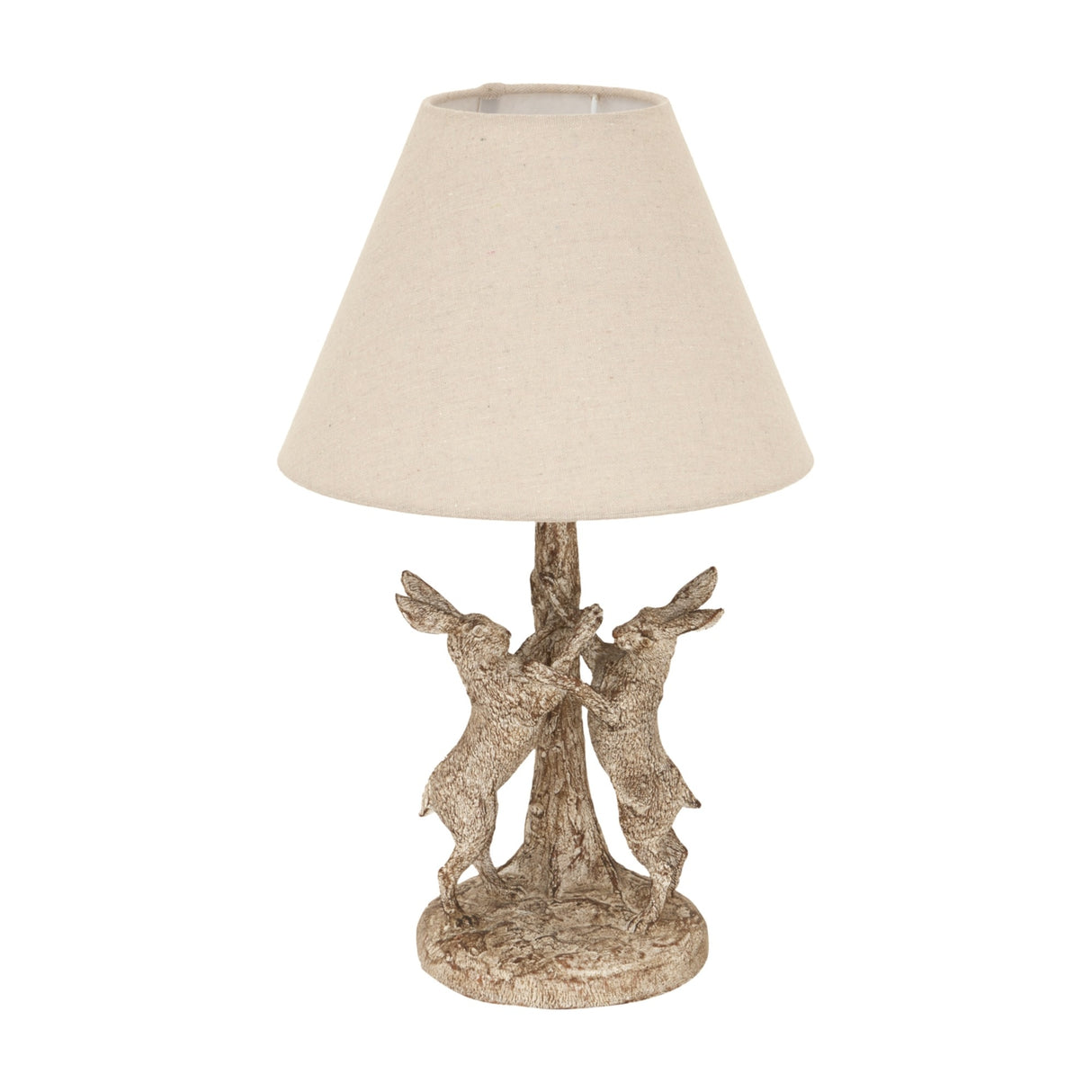 Hill Interiors Marching Hares table lamp with brown resin base of sculpted hares around a tree and natural linen conical shade, on white.