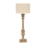 Hill Interiors candlestick table lamp with a turned brown resin base and natural linen drum shade, shown against a plain white background.