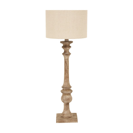 Hill Interiors candlestick table lamp with a turned brown resin base and natural linen drum shade, shown against a plain white background.
