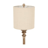 Hill Interiors candlestick table lamp with turned brown resin stem, ball finial and natural linen drum shade, shown against a white background.