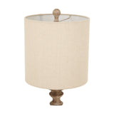 Hill Interiors candlestick table lamp with cylindrical natural linen shade and turned brown resin finial, shown close-up on a white background.
