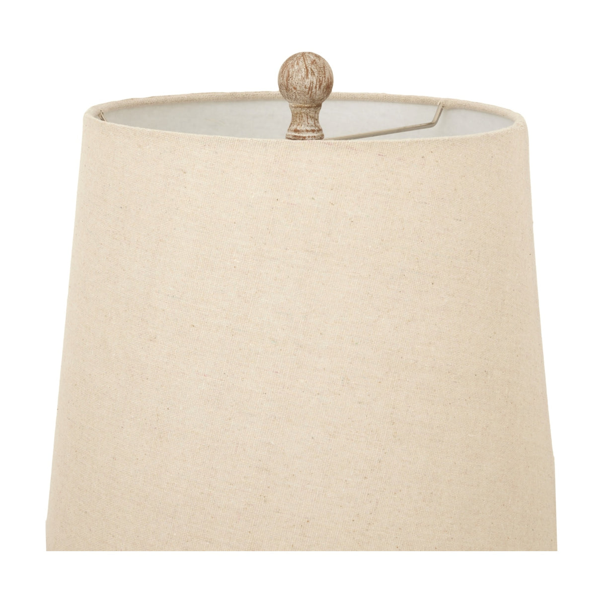 Close-up of the natural linen shade and turned brown resin finial on the Hill Interiors Candlestick Table Lamp against a white background.