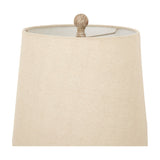 Close-up of the natural linen shade and turned brown resin finial on the Hill Interiors Candlestick Table Lamp against a white background.