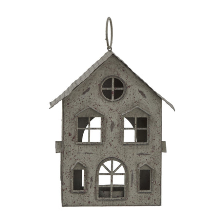 Hill Interiors rustic brown metal hanging house tealight holder with pitched roof, arched and round windows, and top ring hook on a white background.
