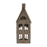 Hill Interiors tall rustic metal house tealight holder in brown, with pitched roof, chimney, arched attic window and cut-out panes, on a white background.