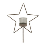Hill Interiors Rustic Star candle holder with a distressed brown metal star frame and clear glass votive on a slim stand, shown against a white background.
