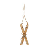 Hill Interiors Natural Rustic Crossed Skis Wooden Ornament in beige with silver snowflake detail, jute bow and hanging loop, on a white background.