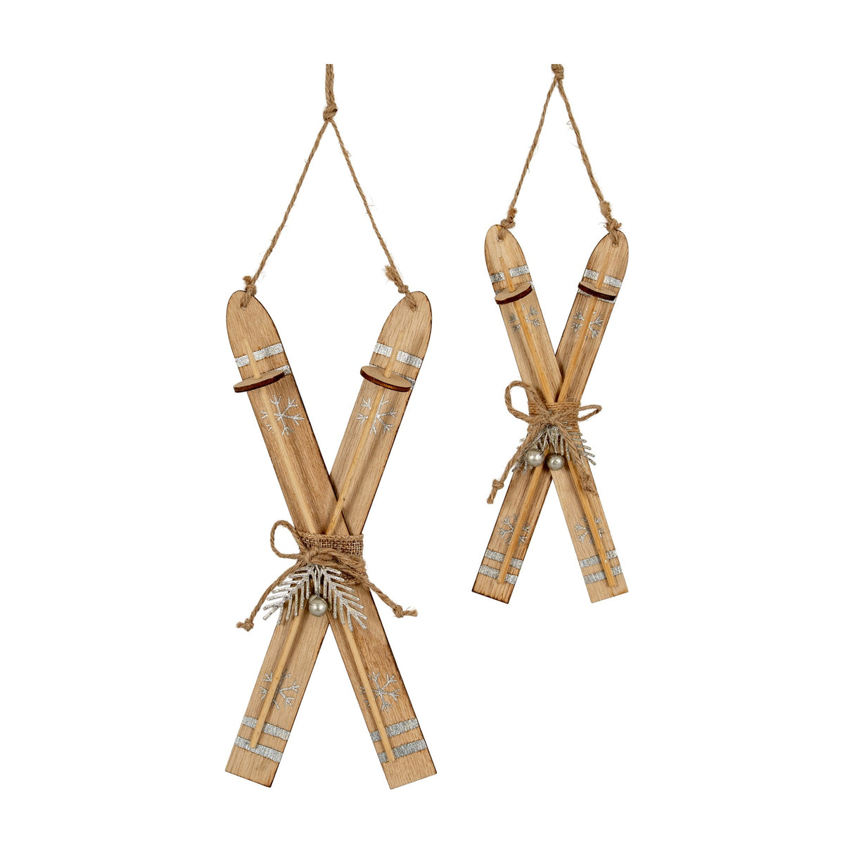 Hill Interiors Natural Rustic Crossed Skis wooden ornaments in beige with silver snowflake detail, jute hanging cords and twine ties, shown in two sizes.