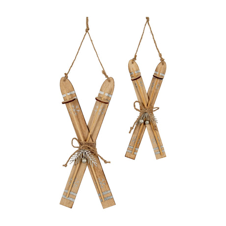 Hill Interiors Natural Rustic Crossed Skis wooden ornaments in beige with silver snowflake detail, jute hanging cords and twine ties, shown in two sizes.