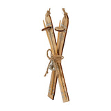 Hill Interiors Natural Rustic Crossed Skis Wooden Ornament in beige with silver snowflake detailing, jute twine bow and hanging loops, on a white background.