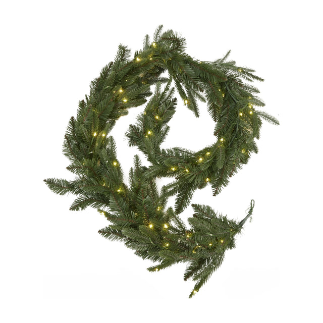 Hill Interiors Pre-Lit Woodland Fir Christmas Garland coiled with green plastic needles and 200 warm white LED lights on a white background.