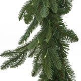 Close-up of Hill Interiors Pre-Lit Woodland Fir Christmas Garland in green, showing dense plastic needles and small warm LED lights on a white background.