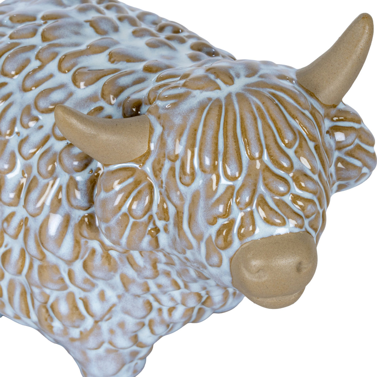 Close-up of Hill Interiors Medium Ceramic Highland Cow Ornament in white glaze, showing textured shaggy coat, tan horns and muzzle.