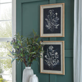 Two Hill Interiors Grove botanical prints on linen in white beaded frames, hung in portrait on a green panelled wall beside a window and foliage vase.