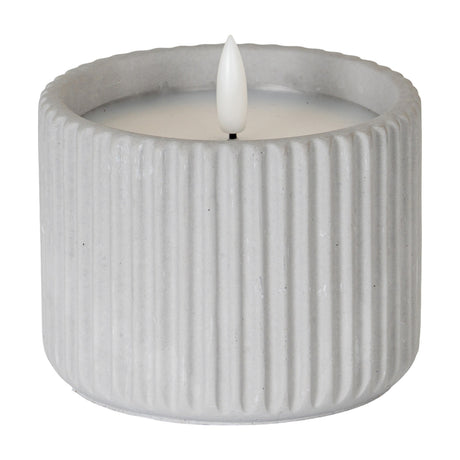 Hill Interiors ribbed chalk-finish LED pillar candle in beige wax with a flame-effect tip, shown on a plain white background.