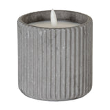 Hill Interiors Ribbed LED Pillar Candle in beige wax with vertical ribbed surface and flickering flame-shaped tip, shown on a plain white background.