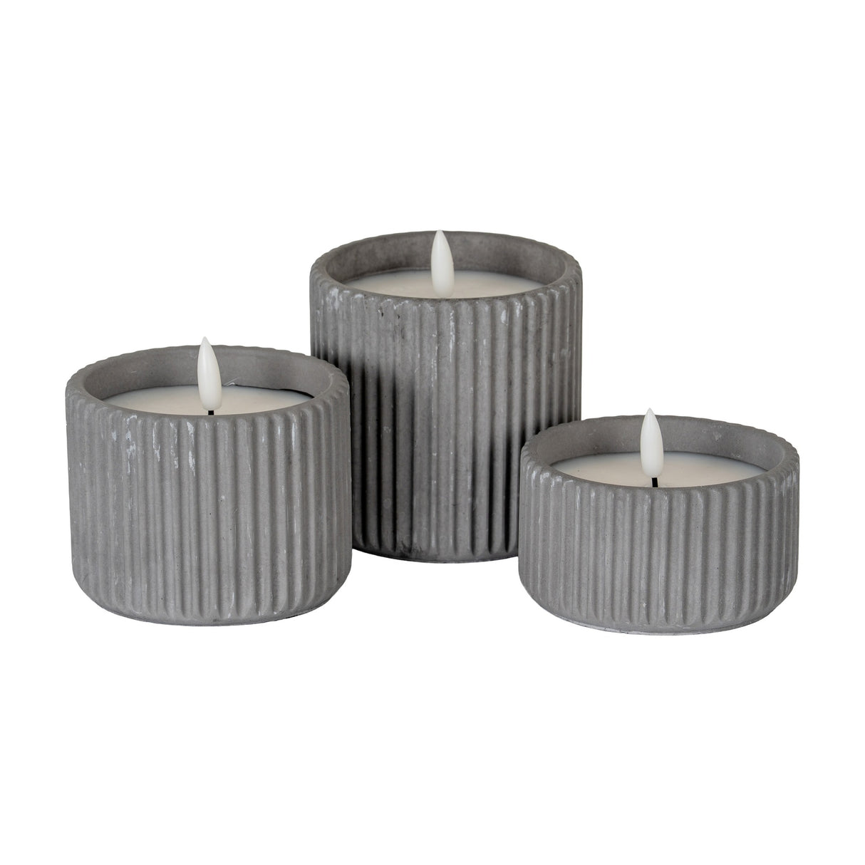 Hill Interiors Ribbed LED Pillar Candles in beige wax, shown as a trio of ribbed cylindrical holders at varying heights with flame-shaped LED tips.
