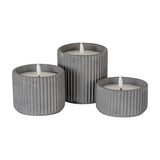 Hill Interiors Ribbed LED Pillar Candles in beige wax, shown as a trio of ribbed cylindrical holders at varying heights with flame-shaped LED tips.