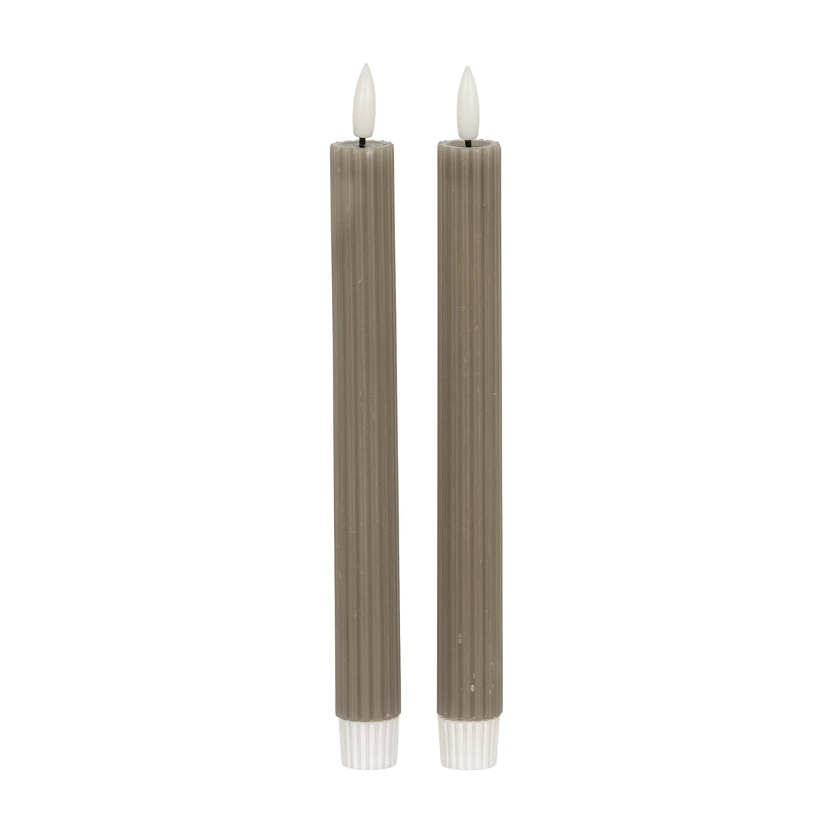 Hill Interiors Ribbed Taper Candles in beige, a pair of slim vertically ribbed wax tapers with lit flame tips, shown on a plain white background.